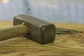 a large iron hammer and nails on a wooden surface Royalty Free Stock Photo