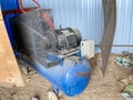 Large iron industrial portable compressor with electric motor in the factory