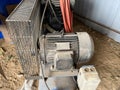 Large iron industrial portable compressor with electric motor in the factory