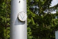 Large iron metal stainless brilliant industrial tank column with a folding round hatch, manhole with bolts, nuts and studs against