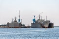 Large iron navy ships in shipyard for repair. Big crane in dockyard. Blue sea harbor Royalty Free Stock Photo