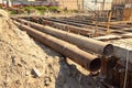Large iron pipes at a construction site Royalty Free Stock Photo