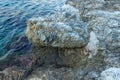 Large iron ring in the rock for mooring boat. Calm sea. Greece.