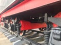 Large iron wheels of a red and black train standing on rails and suspension elements with springs of an old industrial steam Royalty Free Stock Photo