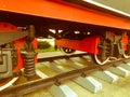 Large iron wheels of a red and black train standing on rails and suspension elements with springs of an old industrial steam Royalty Free Stock Photo