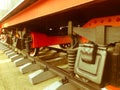 Large iron wheels of a red and black train standing on rails and suspension elements with springs of an old industrial steam Royalty Free Stock Photo