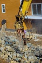 Large jackhammer smashing rocks in the new laying road around home Royalty Free Stock Photo