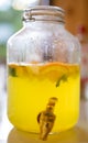 A large jar with fresh homemade lemonade and orange slices