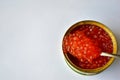 The large jar of red caviar with the spoon