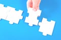 Large jigsaw puzzle pieces on blue desk Royalty Free Stock Photo