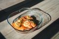 A large juicy piece of fresh salmon with lemon and rosemary in a glass baking dish in the oven Royalty Free Stock Photo