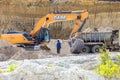 a large kaolin quarry near the city of Kyshtym, Chelyabinsk region. loading the Kamaz truck with an excavator