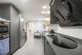 Large kitchen with gray cabinets and black and stainless steel Royalty Free Stock Photo