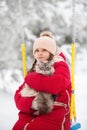 A large labrador dog and a cat in winter on a walk with a young woman in a snowy field Royalty Free Stock Photo