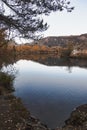 Large lake reflecting autumn trees colors and the mountain Royalty Free Stock Photo