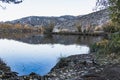 Large lake reflecting autumn trees colors and the mountain Royalty Free Stock Photo