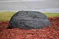 Large Landscape Rock Covered In Red Mulch Royalty Free Stock Photo