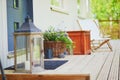 Large lantern and basket full of flowers on the porch Royalty Free Stock Photo