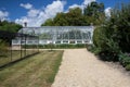 Large lean-to greenhouse in an English country garden Royalty Free Stock Photo