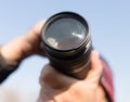 A large lens in the camera of a man