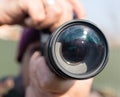 A large lens in the camera of a man