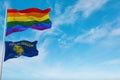 large lgbt flag and flag of Oregon state, USA waving in the wind at cloudy sky. Freedom and love concept. Pride month. activism,