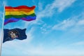 large lgbt flag and flag of Utah state, USA waving in the wind at cloudy sky. Freedom and love concept. Pride month. activism,