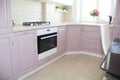 Large light pink kitchen. Interior of a pink kitchen. Wooden Kitchen
