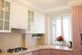 Large light pink kitchen. Interior of a pink kitchen. Wooden Kitchen