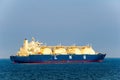 Large liquefied natural gas LNG carrier with 4 LNG tanks sails in the sea