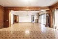 Large living room of a house with wooden parquet floors of various shades and wooden panels on some walls and beams