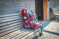 Large loaded backpack with walking sticks and water bottle and sleeping bag and child seat on wooden bench outside wooden Royalty Free Stock Photo