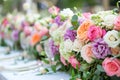 A large, long, decorated table , covered with a white tablecloth with dishes, flowers. Wedding banquet. close up Royalty Free Stock Photo