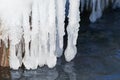 Large, long icicles on water background. selective focus