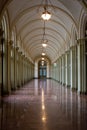 Large long passage walk way with marble floor, arches and pillars