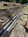 A large long pit with old pipes at the bottom during the elimination of the accident and their replacement Royalty Free Stock Photo