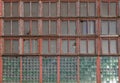 Large long windows in a large old abandoned industrial factory building, closeup. Royalty Free Stock Photo