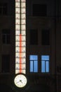 Large luminous thermometer on the facade of the building and a large clock. Kharkiv city, Ukraine - December 9, 2024 Royalty Free Stock Photo
