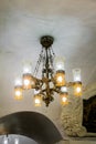 Large luxurious chandelier under the ornamental arched ceiling.