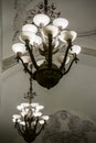 Large luxurious chandeliers under the ornamental arched ceiling.