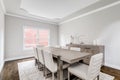 A large, luxurious dining room with a wooden table and chairs.