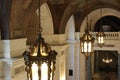 Large luxurious lanterns hanging from the ceiling of cathedral