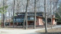 Luxurious, Prairie-style House with Bare Trees in Wooded Setting Royalty Free Stock Photo