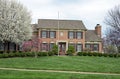 Beautiful Red Brick Home with Spring Flowering Trees Royalty Free Stock Photo