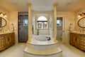 Large luxury bathroom with centerd bathub.