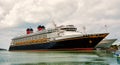 Large luxury cruise ship Disney Wonder on sea water and cloudy sky background docked at port of Nassau, Bahamas