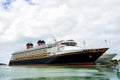 Large luxury cruise ship Disney Wonder on sea water and cloudy sky background docked at port of Nassau, Bahamas Royalty Free Stock Photo