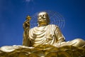 A large figure of a seated golden buddha