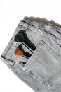 Large makeup brushes in pocket of gray jeans. Concept, commercial work of a makeup artist, for printing business cards and