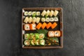 Large maki sushi set with a varied assortment of Japanese rolls in a square plate